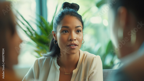 A photograph of a african american woman engaging in a dynamic conversation with interviewers