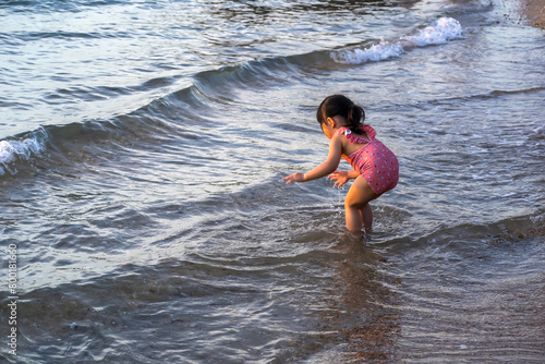 Girl playing in the water at the beach.