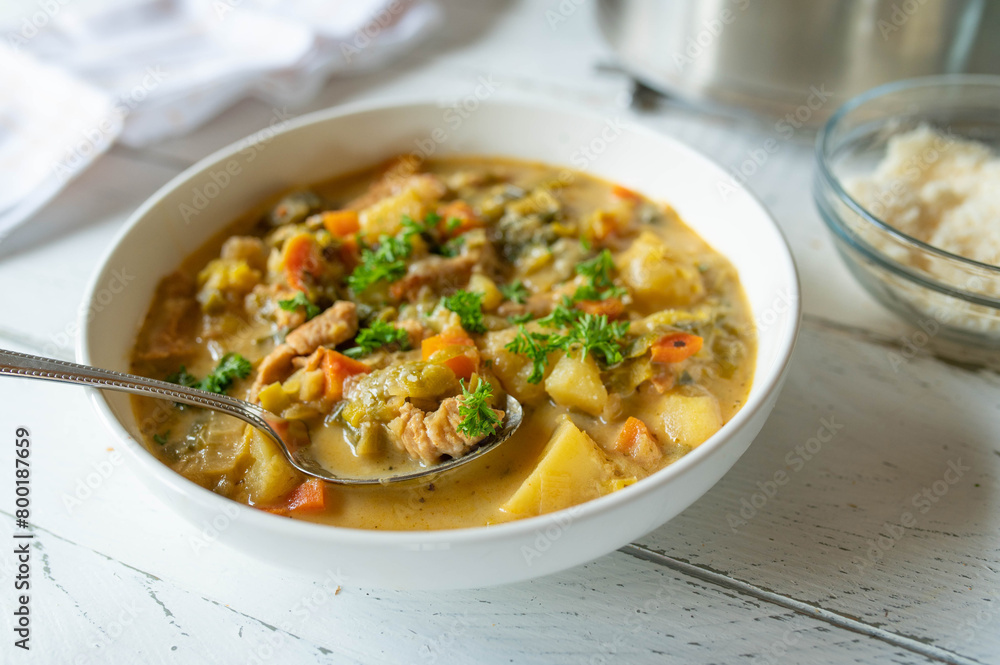Potato soup with leek and turkey meat on a plate Potato soup with leek and turkey meat on a plate