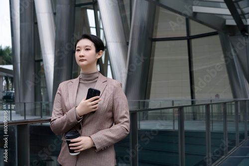 Professional Woman with Phone by Modern Architecture © 昊 周