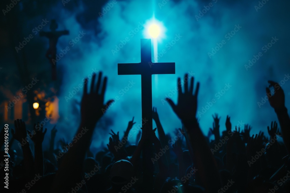 A crowd of various people are raising their two hands to the air to praise the Lord and gathered around a wooden cross settled at a mound among the cloudy sky. Religion and faith in God. A crowd of various people are raising their two hands to the air to praise the Lord and gathered around a wooden cross settled at a mound among the cloudy sky. Religion and faith in God.