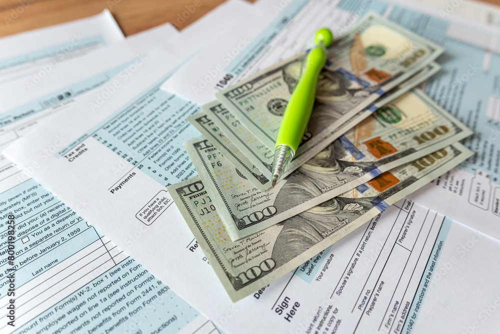Fototapeta premium 1040 Individual Income US tax form with dollars business concept