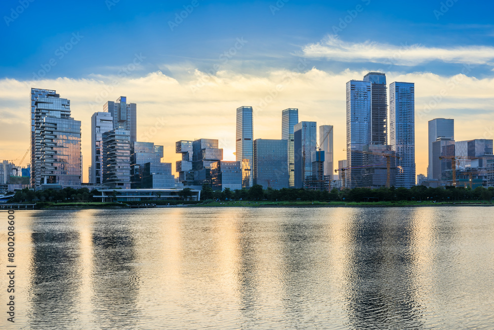 Shenzhen skyline and modern commercial buildings scenery at sunset, China. modern city buildings by the lake. Shenzhen skyline and modern commercial buildings scenery at sunset, China. modern city buildings by the lake.