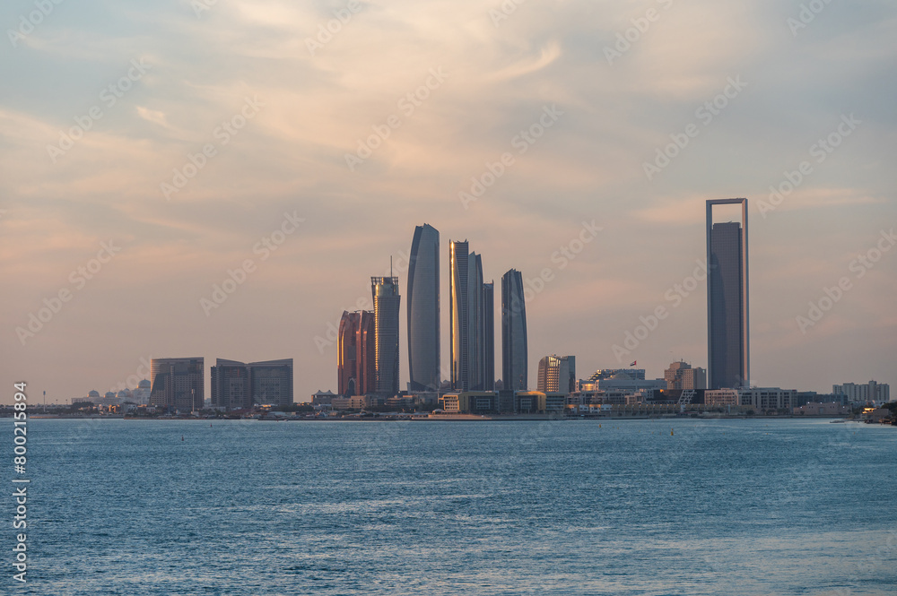 Perspective of skyscraper towers and bay cityscape skyline of Abu Dhabi, sunrise in UAE.