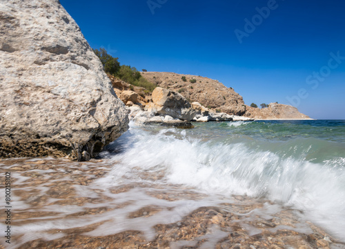 Waves at Akdamar Island's beach and blue sky for purpose of web and design use