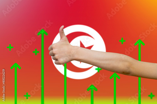 Tunisia flag with green up arrows, country statistics concept,  finger thumbs up front of Tunisia 