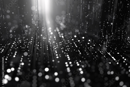 monochrome digital rain with bright vertical light streaks and scattered glowing dots on a dark background photo