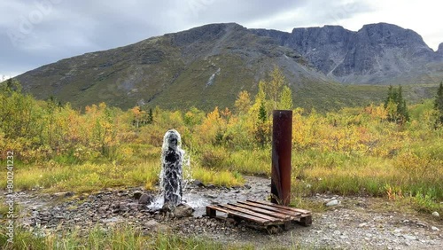 An underground geyser in Khibiny. Lake Maly Woodyavr. The purest water comes out of the ground. Valley of geysers. A thermal spring located in the middle of an endless valley, in a mountainous area.4К photo