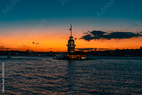 Fiery sunset over the Bosphorus with the famous Maiden's Tower, the symbol of Istanbul. Wallpaper or scenic travel background.