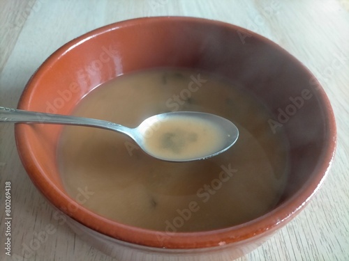 Freshly made Miso soup in a clay bowl with the smoke from the heat of the freshly made soup. (typical Japanese)
