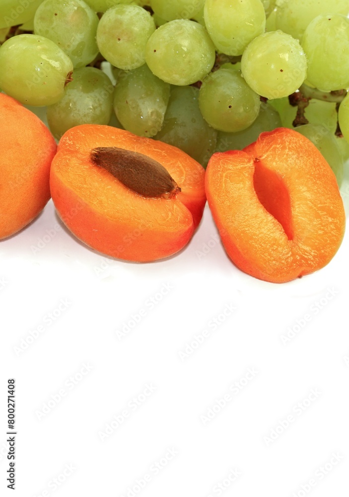 fresh apricots and grapes on a white background fresh apricots and grapes on a white background