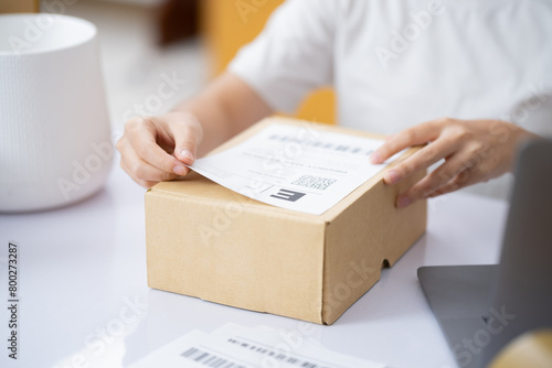 The business of shopping online. Attaching Shipping Label to a Parcel.