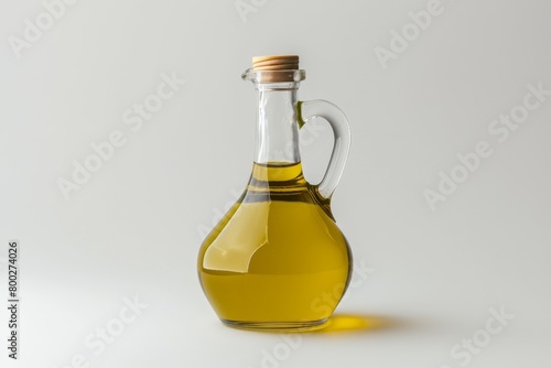 Olive oil in plastic bottle with handle against white background