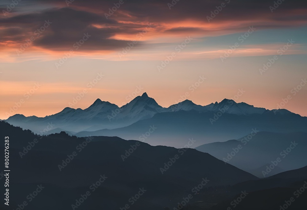 the mountains in the distance are lit up at sunset with pink and orange hues
