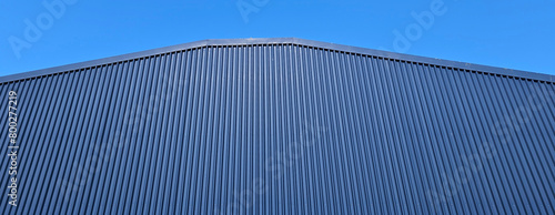 Minimalist blue building roofline and clear blue sky