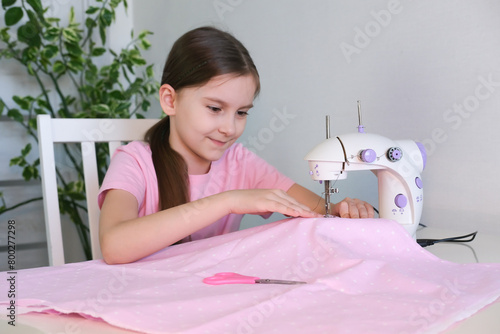 Teenage girl prepares sewing machine for work, inserts thread. Hobby sewing as small business concept.