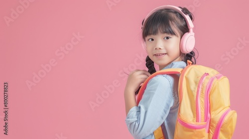 Portrait Asian primary school student girl with headphones and backpack pink background. Generate AI