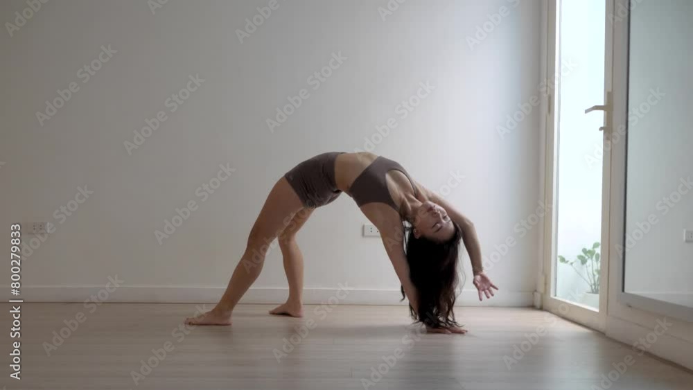 Young woman, Yoga one-legged wheel, strengthen back, arms, and legs Young woman, Yoga one-legged wheel, strengthen back, arms, and legs