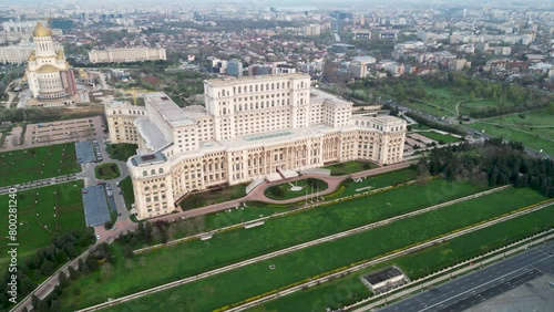 Aerial drone footage of the People's Palace in Bucharest Romania. Romanian Parliament seen from above on a green spring day. Brutalist architecture landmark of post-communist Europe.
 photo
