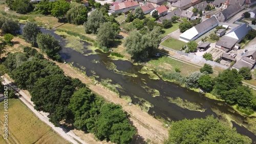 Stagnant canal running through small village of Batya, Hungary, aerial view. photo