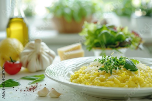 Risotto alla milanese served with salad Made with saffron rice butter cheese and broth Raw arborio rice in background White table