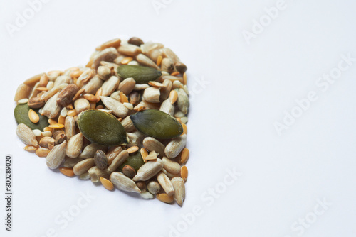 Healthly Eating Shot With Nuts And Seeds In Shape Of A Heart On White Background
