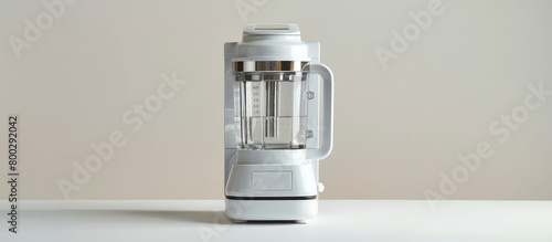 Modern electric blender with splashes of clear water on a simple background with copy space. Advertising banner of kitchen appliances. photo