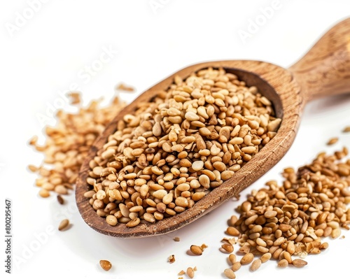 Scoop of sesame seeds on white background