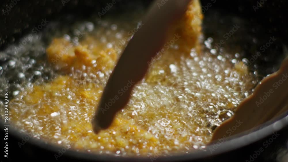 Frying breaded chicken fillets in oil in a frying pan. Slow motion Frying breaded chicken fillets in oil in a frying pan. Slow motion