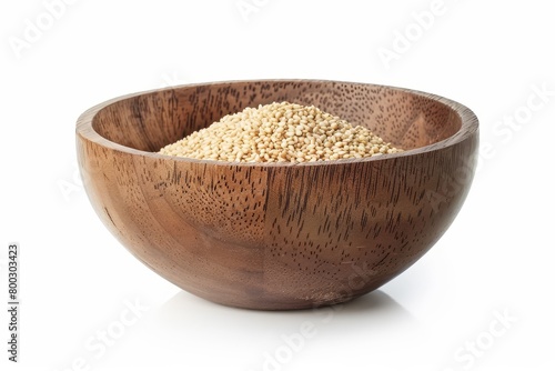 Wooden bowl with sesame seeds on a white surface photo