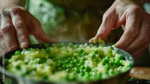 Chef's hands preparing green pea risotto in a black skillet, focused cooking scene. Culinary arts and nutrition concept