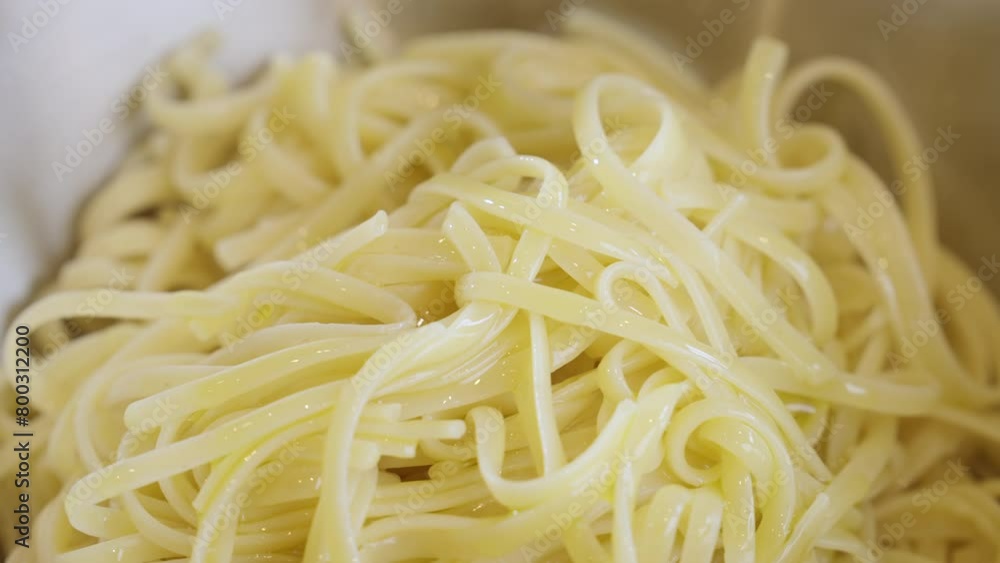 Close up of extra virgin olive oil being poured over spaghetti. Close up of extra virgin olive oil being poured over spaghetti.