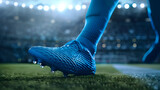 Close up of a soccer player's blue shoe on grass in a stadium, with a blurred background showing sunlight and a bokeh effec