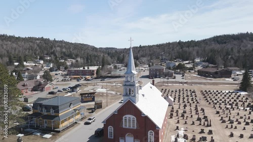 drone above Saint-CômeLanaudière region of Quebec Canada fly above old colonial church in mountains pine tree forest valley  photo