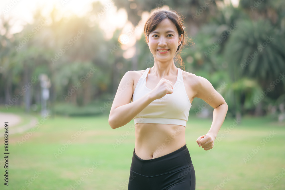 pretty asian woman jogger running in green nature public park. pretty asian woman jogger running in green nature public park.