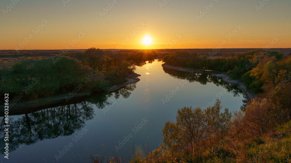 beautiful spring landscape, panoramic view of river and forest from above the hill, bright sunny day turns into sunset and dusk, sunlight reflects from water, river bank and flow of water