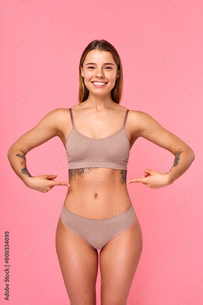 Fototapeta premium Cosmetology, beauty and spa treatment. Woman in lingerie on pink background.