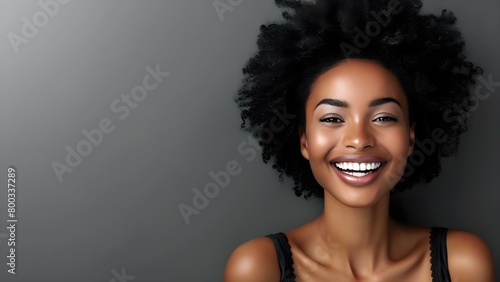 A happy Afrohaired woman recommends a product laughing sincerely in a casual outfit. Concept Portrait, Lifestyle, Fashion, Afrohaired Woman, Product Recommendation photo