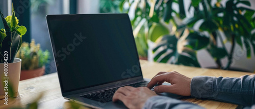 Business person working online or learning using laptop mock up blank white empty screen, hands typing on computer background close up view. Mockup display for ads. Close up view. photo