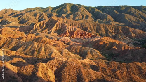 A fabulous canyon in Central Asia. Scenic view of a beautiful textured multi-layered canyon. Mountain ranges in a fabulous canyon at sunset near Lake Issyk-Kul in Karakol. Drone 4K