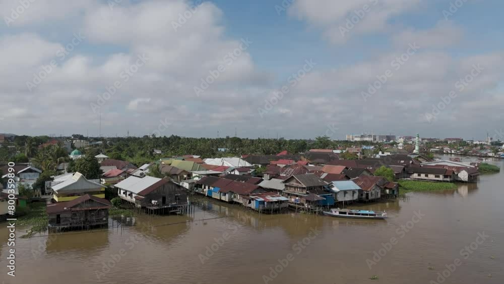 Aerial view of villages and bridges on the riverbank located in the city of Banjarmasin Aerial view of villages and bridges on the riverbank located in the city of Banjarmasin