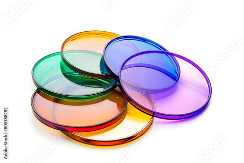 Glass round filters of different colors and sizes are isolated on white background. .