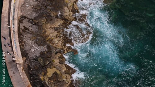 Coastal aerial footage with beautiful waves and rocks shot from above with drone