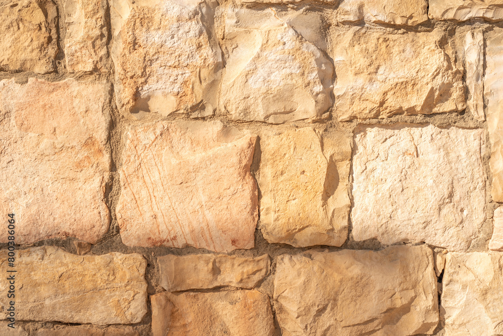Stone wall texture background. Yellow stone texture. Brick wall..
