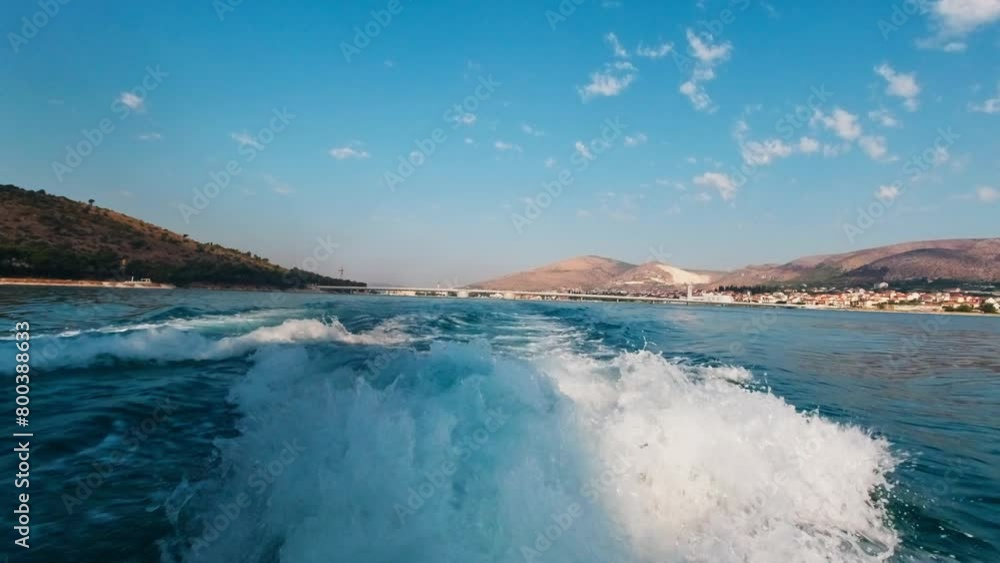 A trace on the water left by a speedboat A trace on the water left by a speedboat