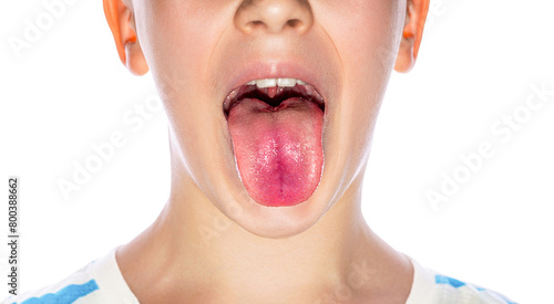 Little boy showing her tongue. Child puts out tongue - close up. Little boy sticks out his tounge. Child showing his tongue on white background, closeup. Health and medical concepts photo