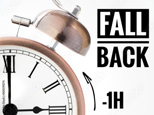  Fall back or time change concept. Alarm clock at 3 o'clock changing to Winter Time