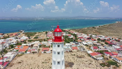 Aerial view of the Farol lighthouse island located in the Algarve tourist region on Portugal's southern coast. View of the Ria Formosa.