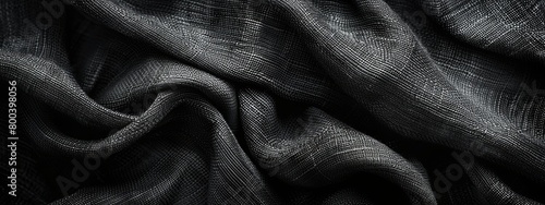 Close-up twisted black fabric with a refined texture.