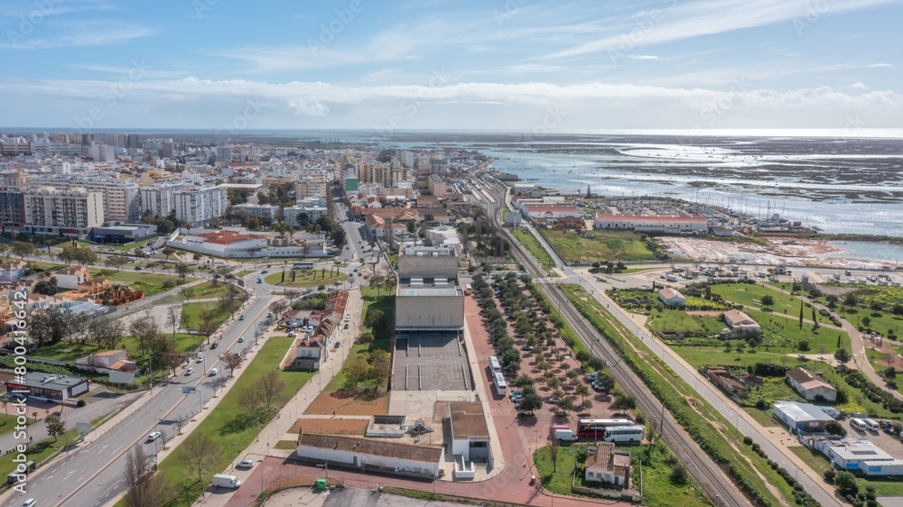Fototapeta premium The Portuguese oceanfront city of Faro overlooking a theater, filmed with a drone. Ria Formosa in background. Algarve.